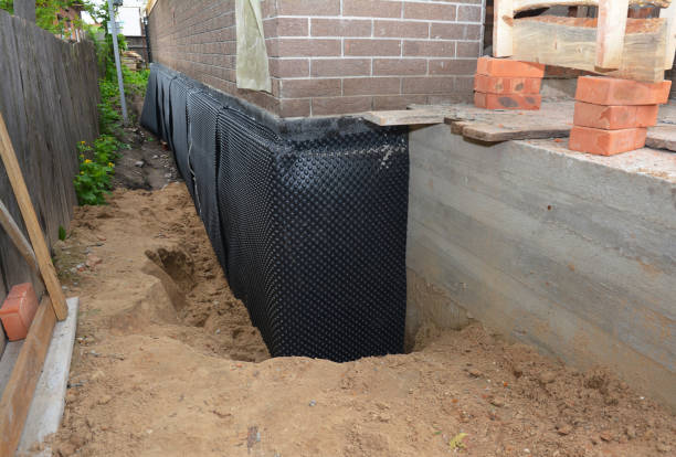 Happy homeowners after waterproofing job in Barker